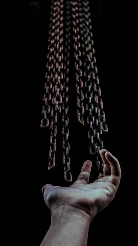 chains being released from someone's hand