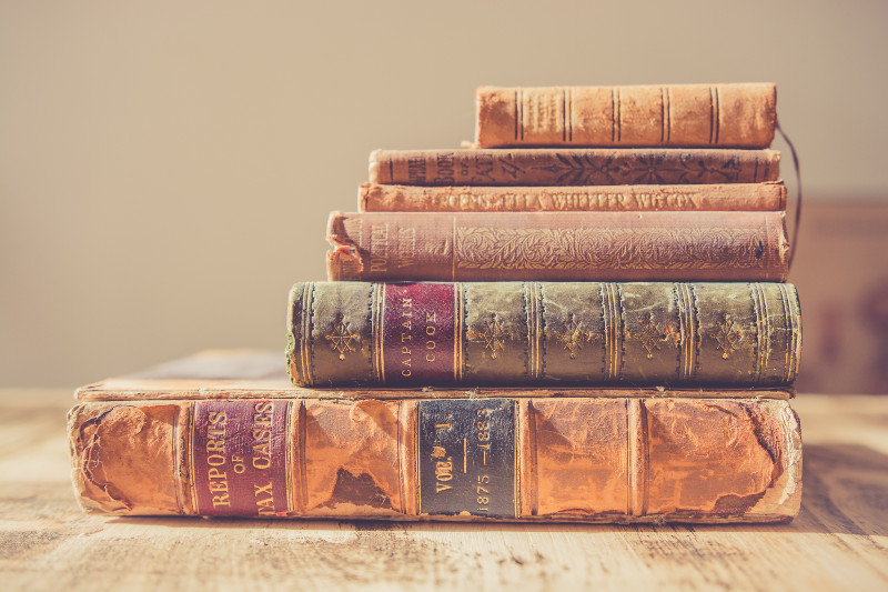 A tack of old books on a table